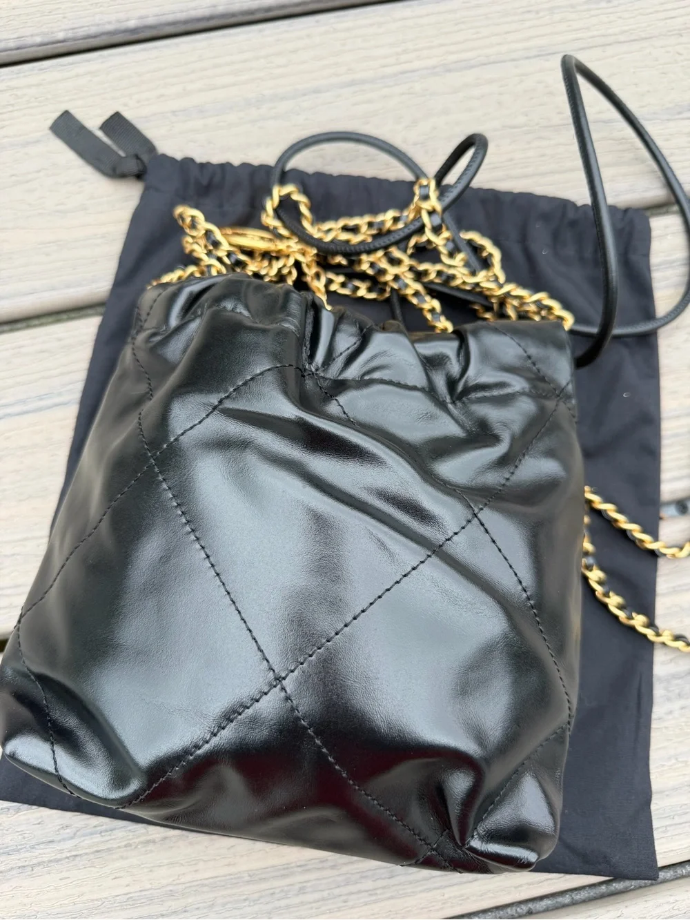 CHANEL Black Quilted Leather Drawstring Crossbody with Gold Chain